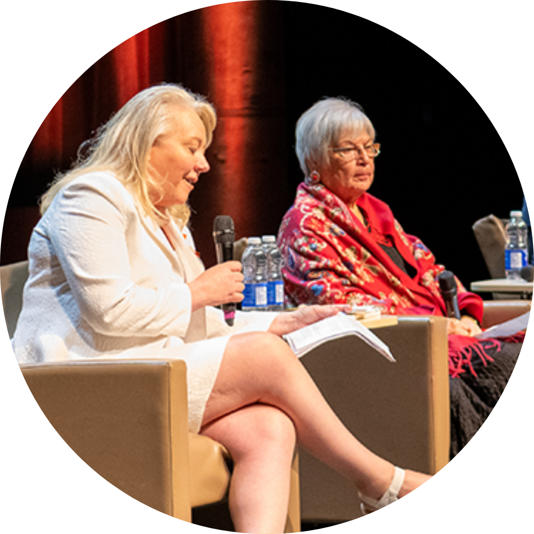 a photo of the Lunch and Learn event - 2 women on stage in chairs speaking out to an audience
